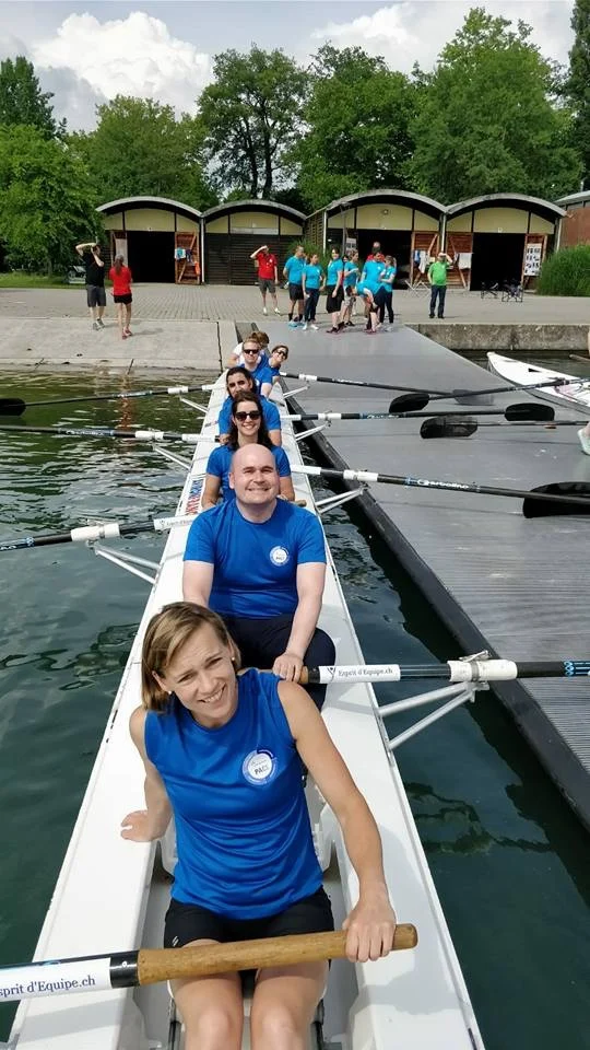 A smiling team ready to set off from the pontoon during an Esprit d'Équipe Rowing outing