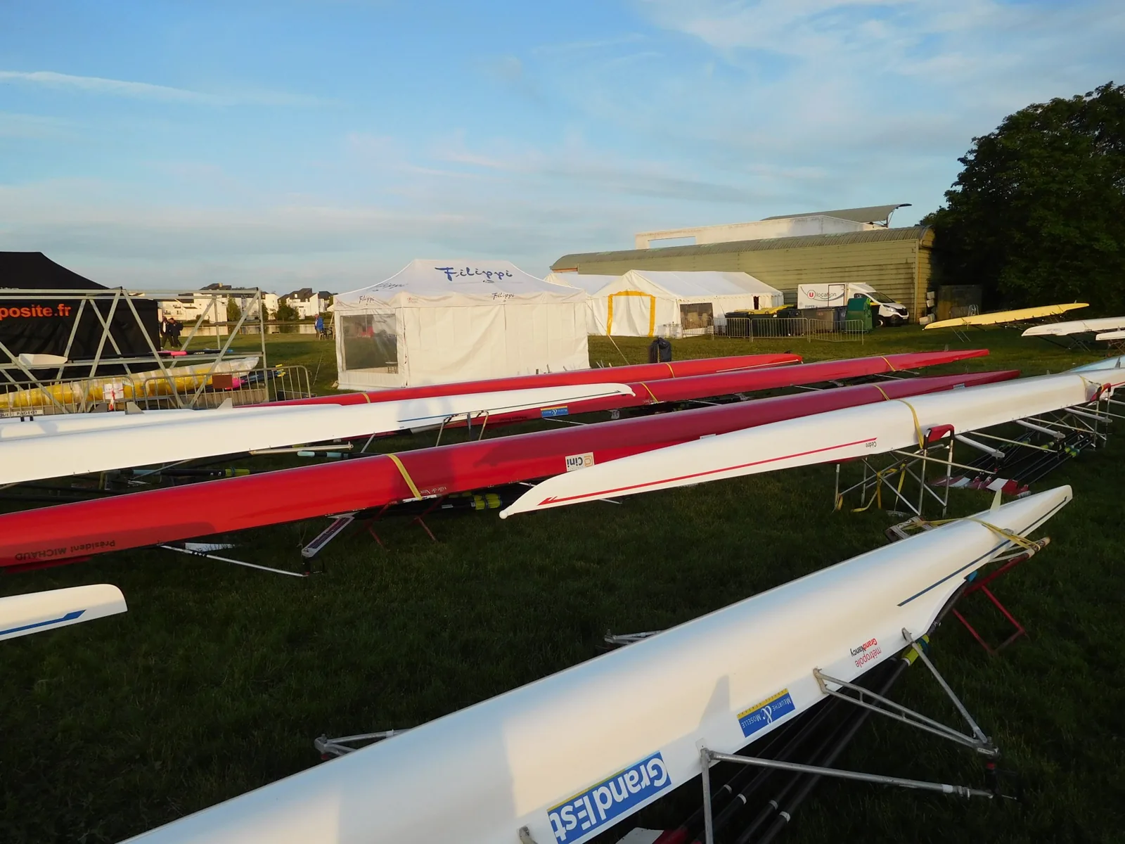 Illustrative photograph: rowing boats and blades arranged on racks before a regatta