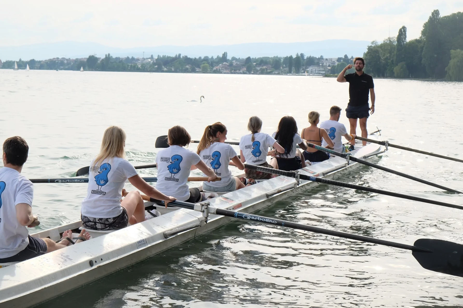An instructor sets the pace for a corporate crew on the lake